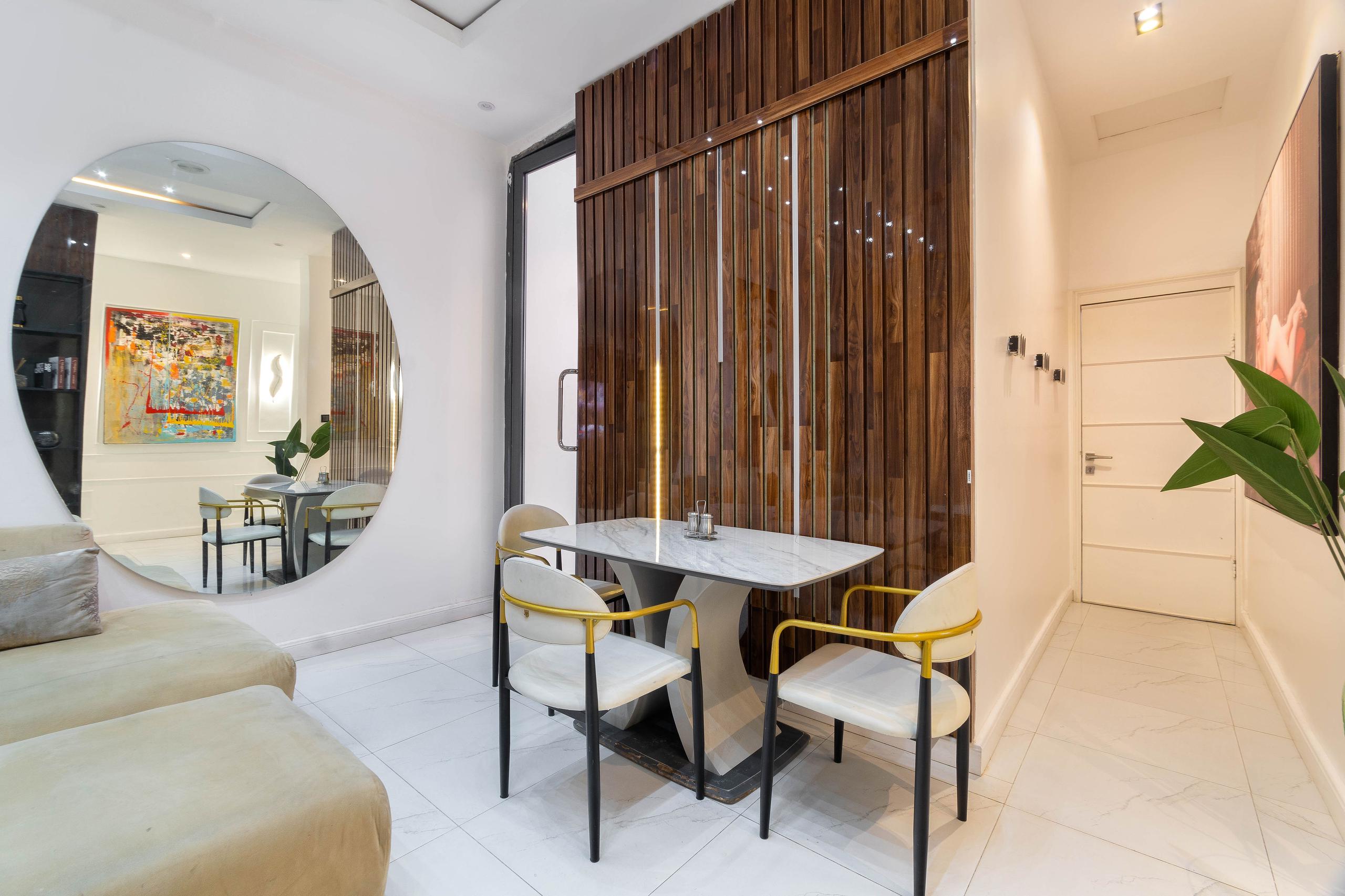 Dining Nook with Circular Mirror and Walnut Slats